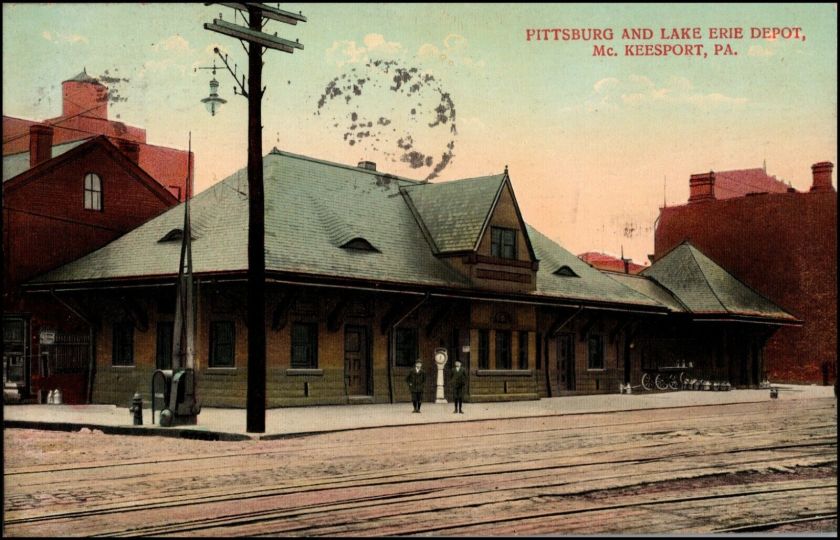 Historical photograph of the Pittsburg and Lake Erie Depot in McKeesport, Pennsylvania, featuring the distinctive architecture of the station, with people standing outside and vintage vehicles nearby.